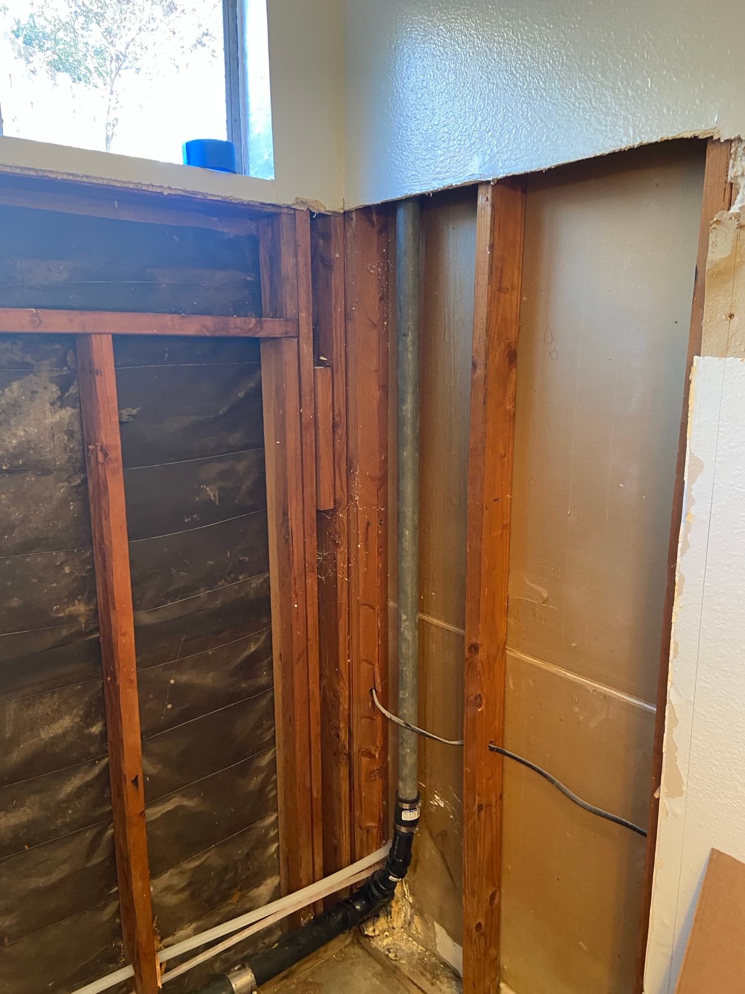 Black ABS vent pipe running through exposed ceiling joists, Orange County, CA remodel
