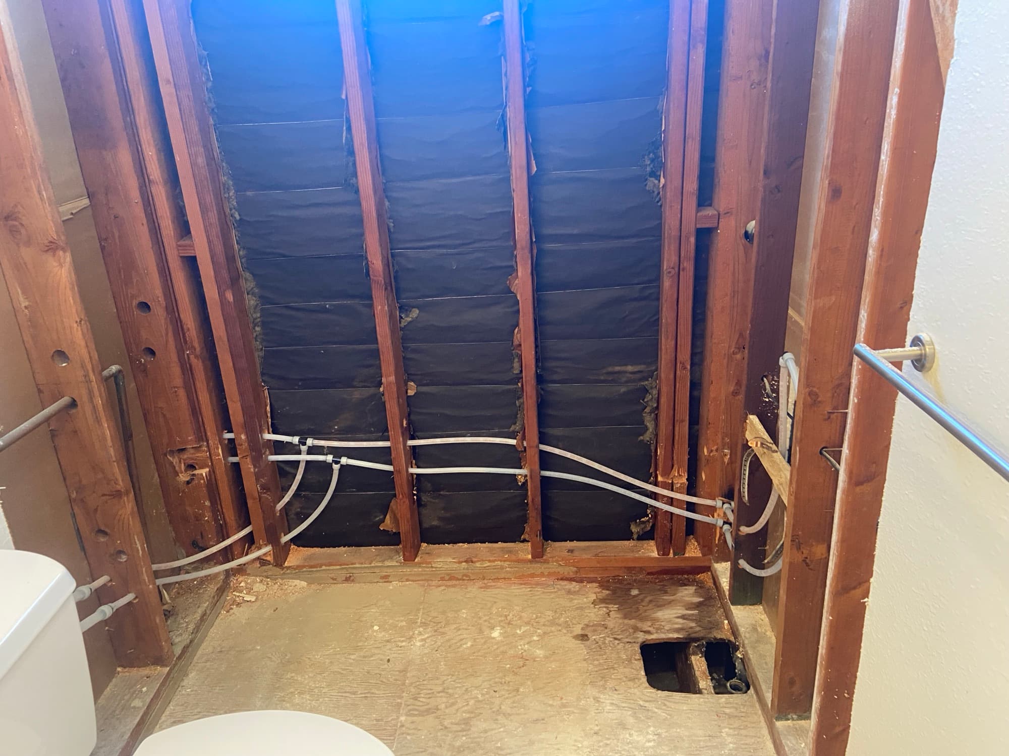 Bathroom stripped to the studs with PEX plumbing lines run for a remodel, Orange County, CA