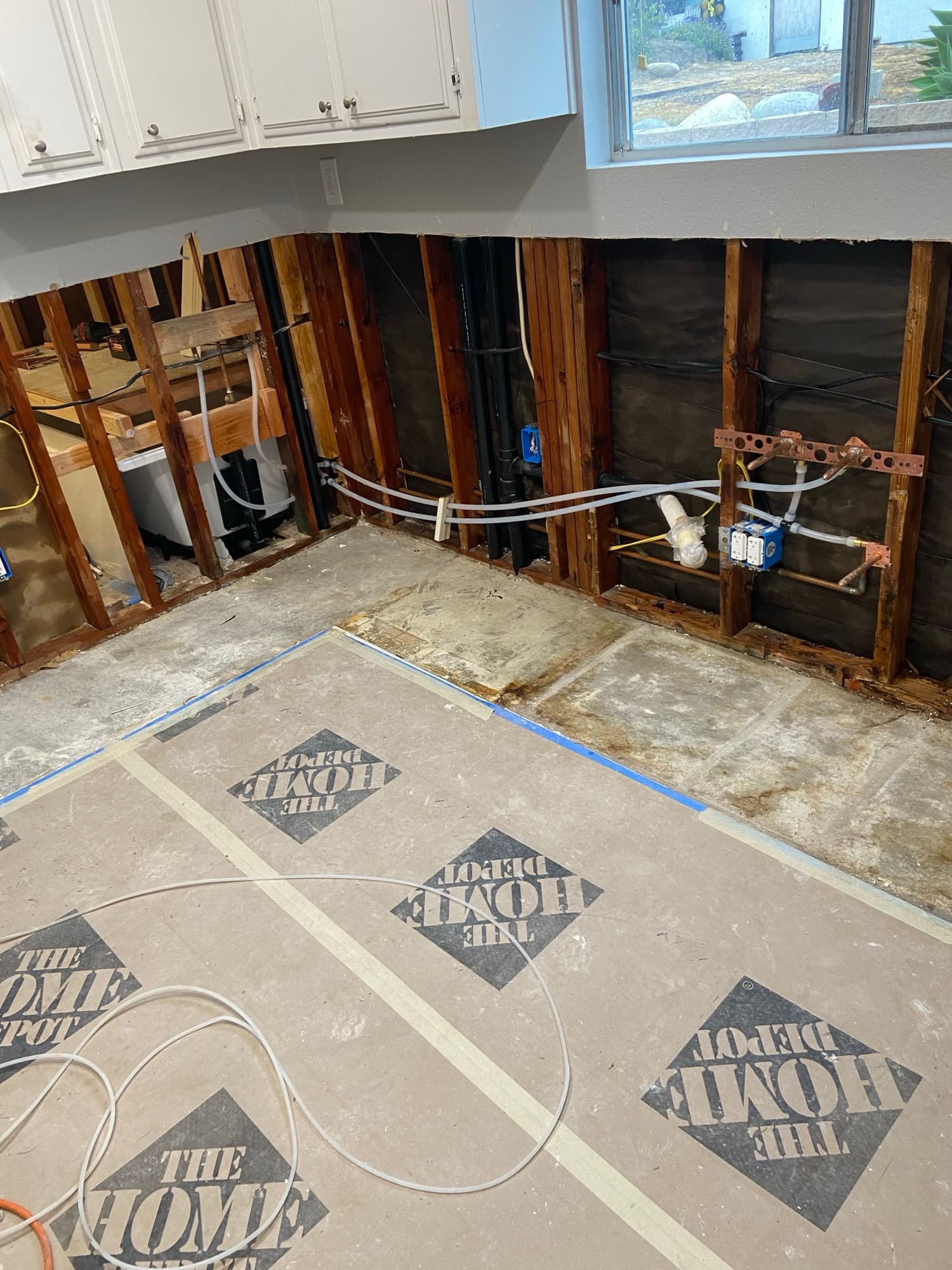 Copper stub-outs and PEX tubing installed in ceiling framing above a kitchen, Orange County, CA