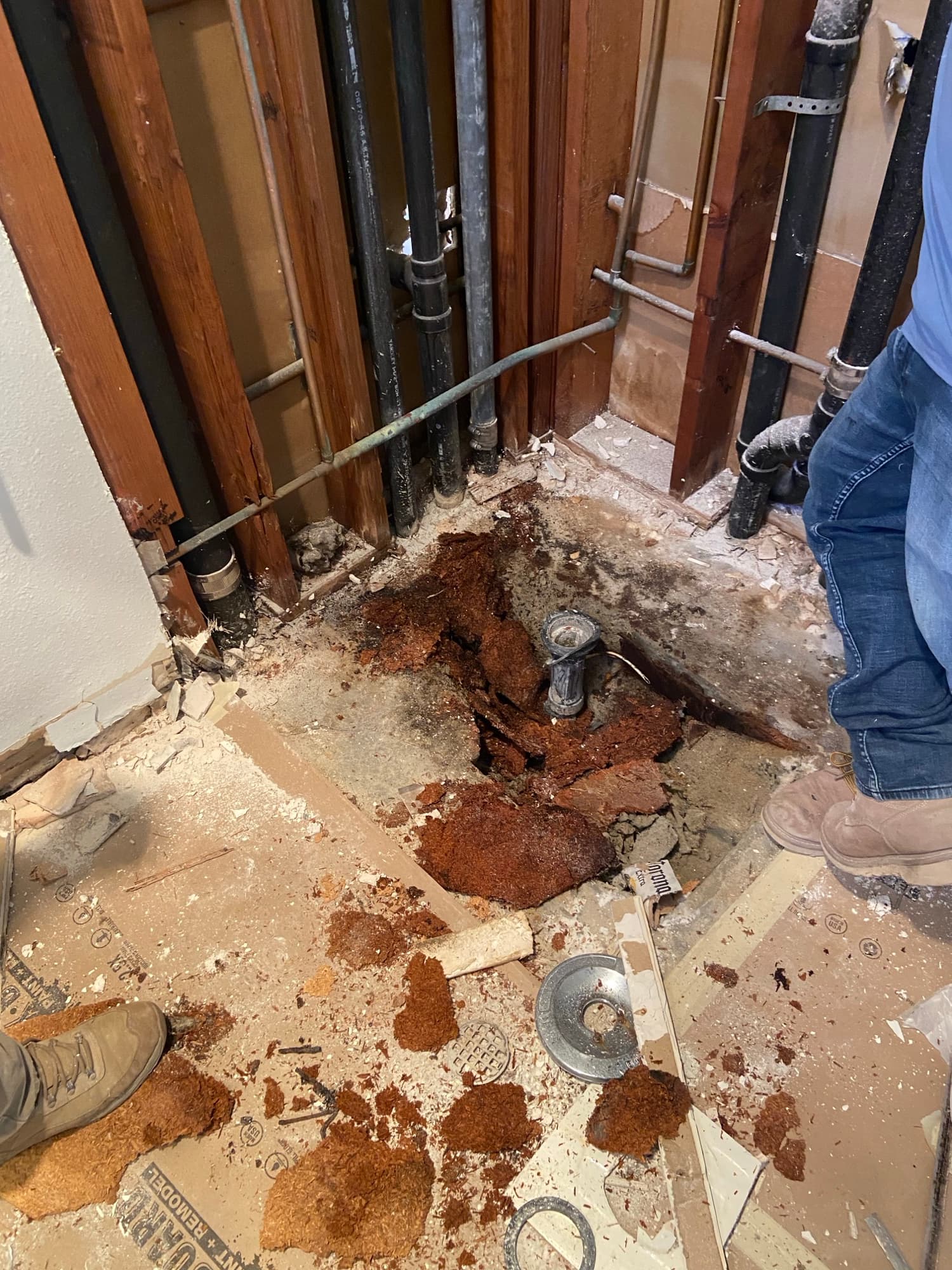 Corroded cast iron drain pipe exposed during a crawlspace repipe in Orange County