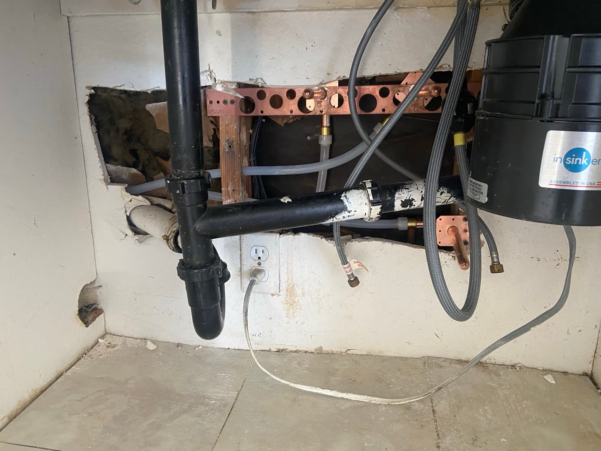 Under-sink plumbing with a garbage disposal unit and drain trap connections, Orange County, CA