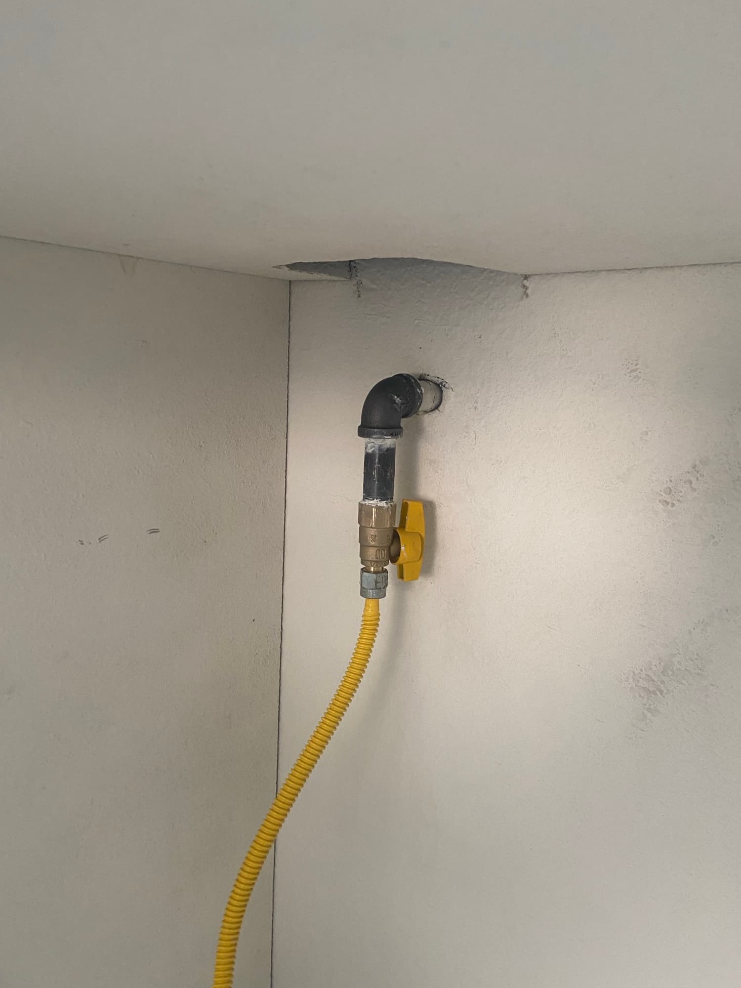 Gas line shutoff valve fitted with a yellow flexible connector, Orange County, CA