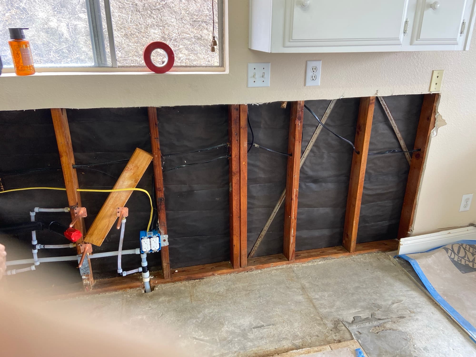 Overhead plumbing framing with copper stub-outs routed above kitchen cabinets, Orange County, CA