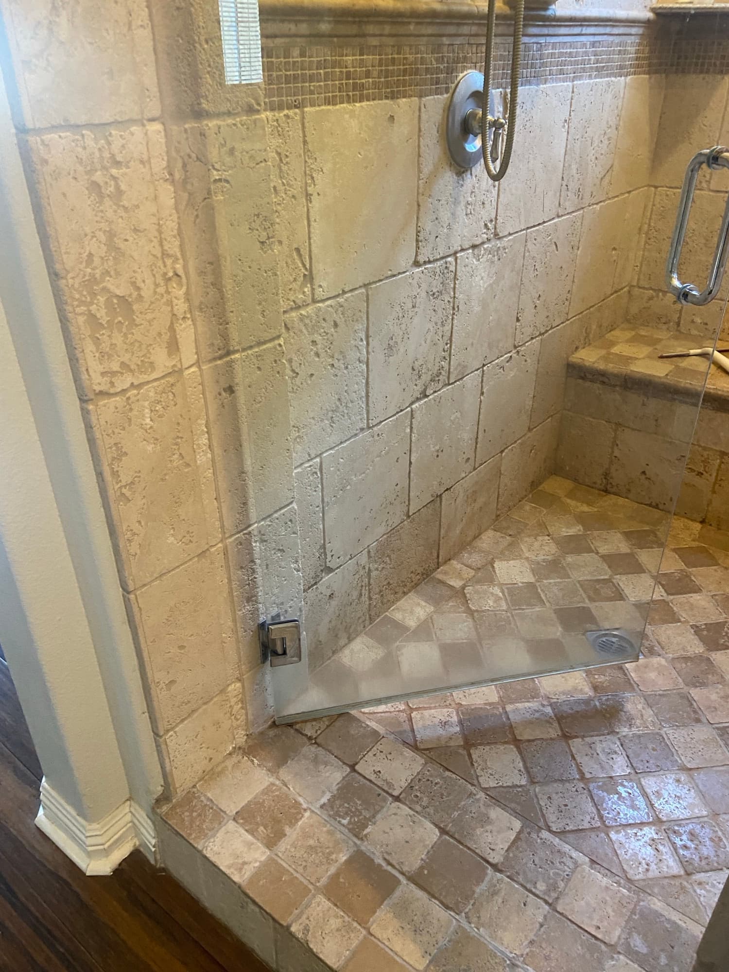 Tiled walk-in shower stall with a glass panel and linear floor drain, Orange County, CA