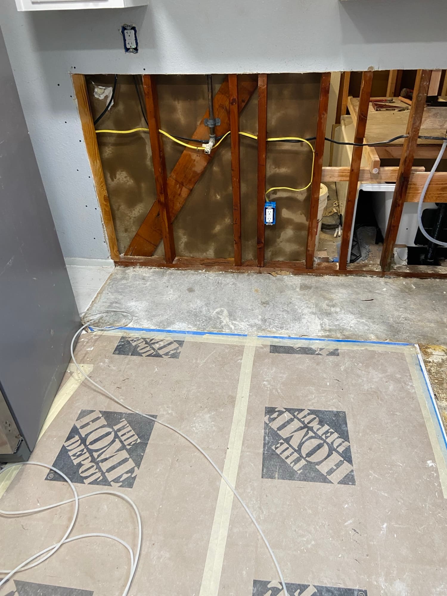 Open wall cavity with diagonal bracing and a plumbing shutoff valve exposed, Orange County, CA