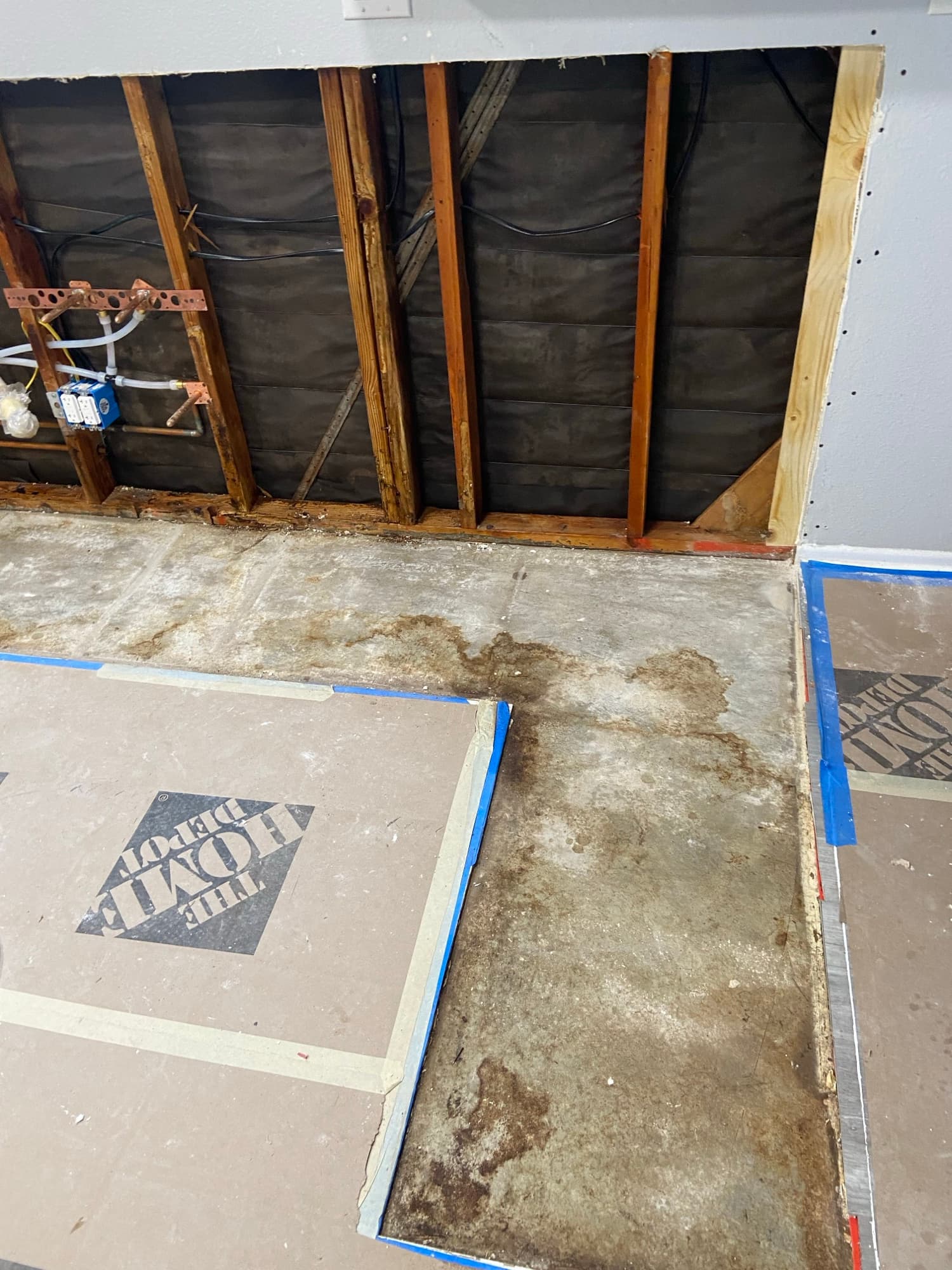 Water staining and mold exposed in a wall corner during plumbing repairs, Orange County, CA